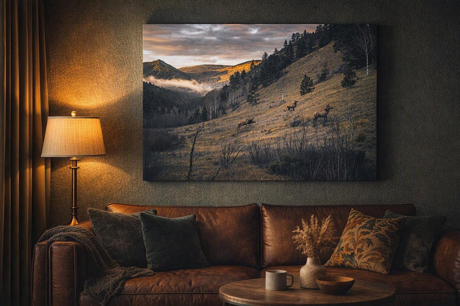 Elk herd wall art in a black frame above a walnut desk with warm lamp light in a masculine office