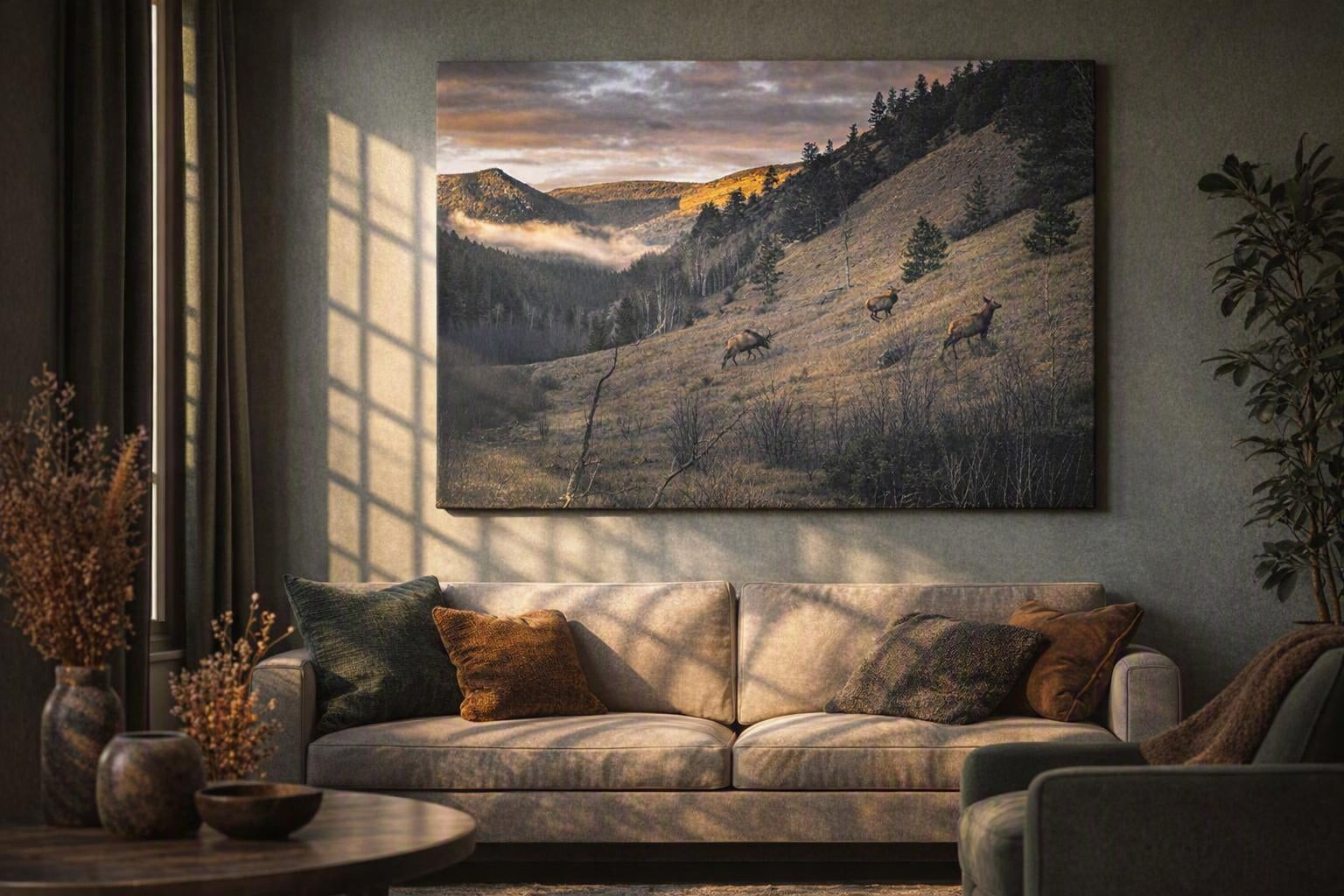 Elk herd wall art in a walnut frame above a stone fireplace with soft window light in a mountain lodge