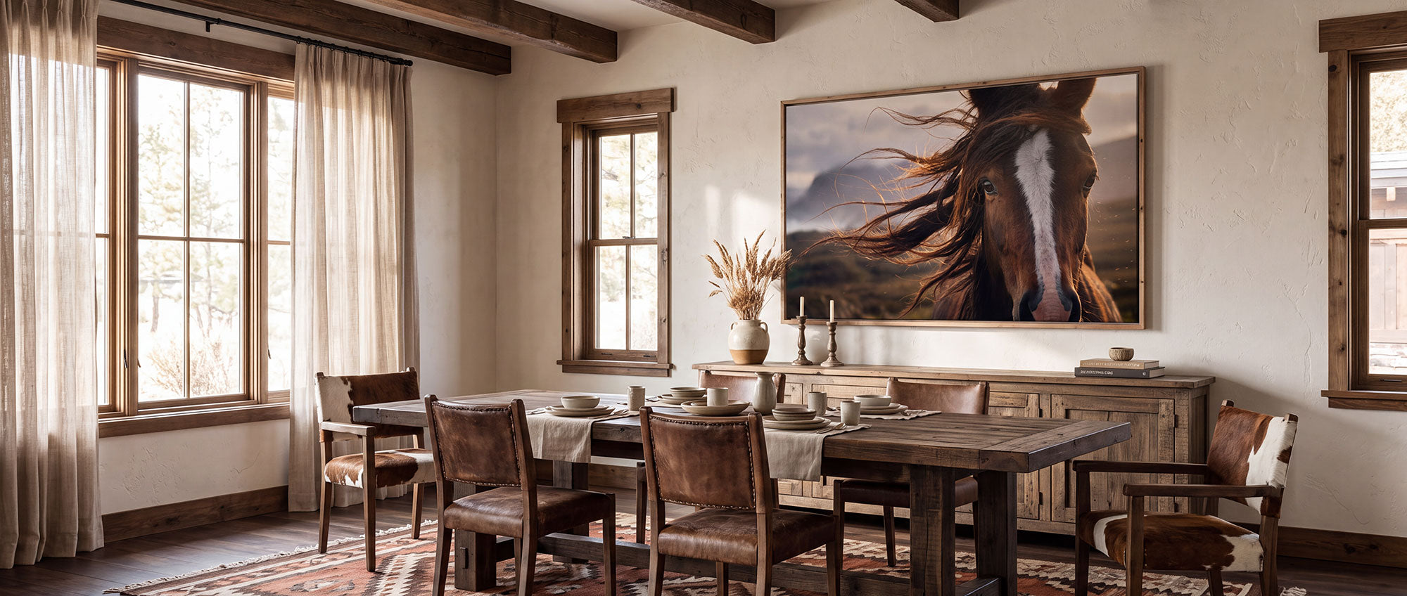 A large framed wall art print depicting a horse's face in motion, displayed in a rustic dining room with a wooden dining table, chairs, and sideboard.